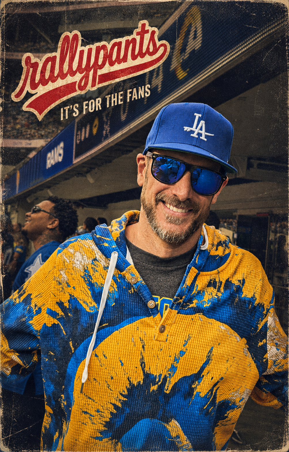 Rallypants fan wearing a blue and gold game-day outer layer in a stadium setting